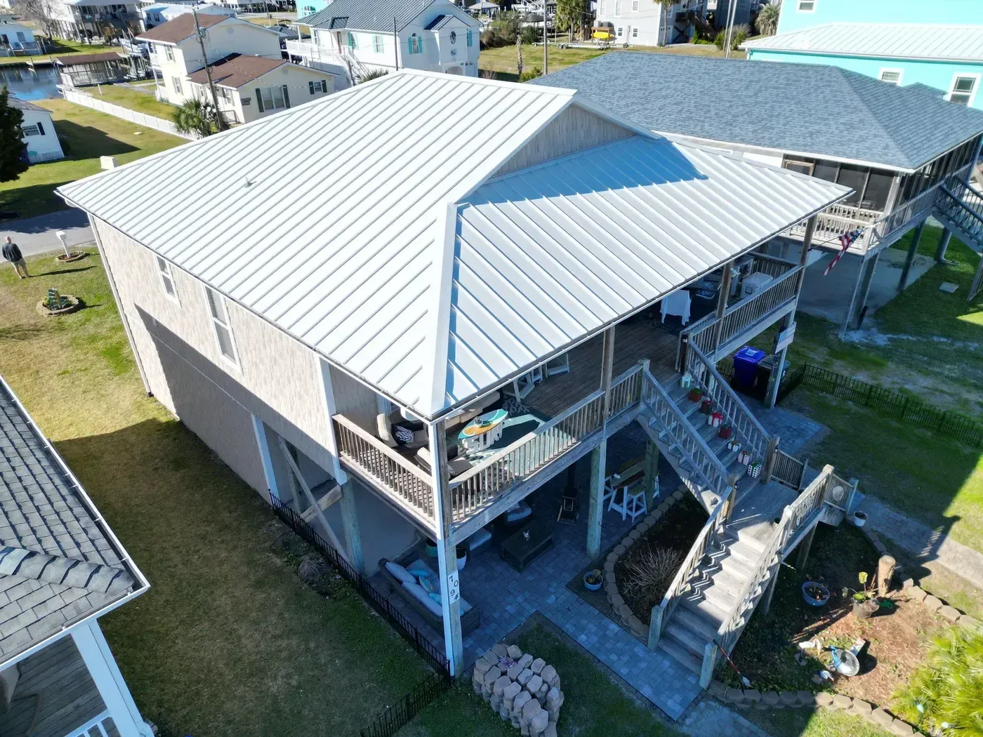 Completed standing-seam metal roof replacement on a coastal home on 7th St in Surf City, NC