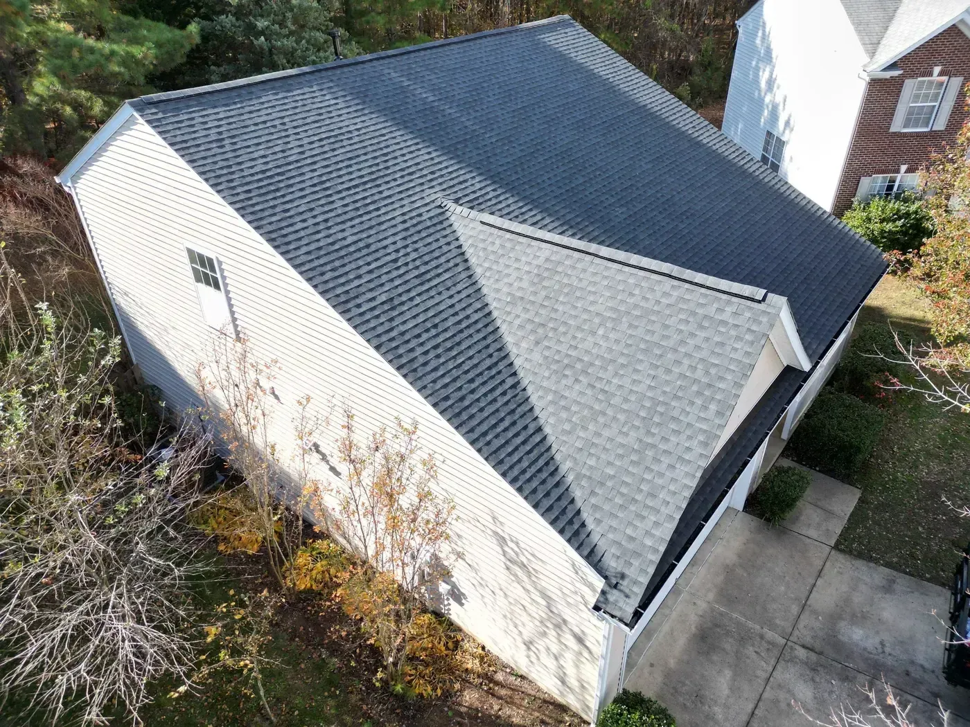 On Tops Roofing team member performing a roof inspection on a Durham, NC home