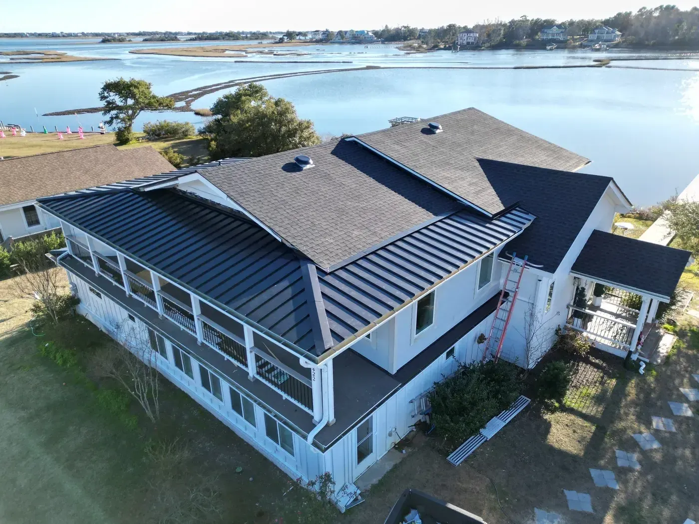 Close-up of a finished roof repair section on Batson Rd in Hampstead, NC with matching GAF Charcoal shingles