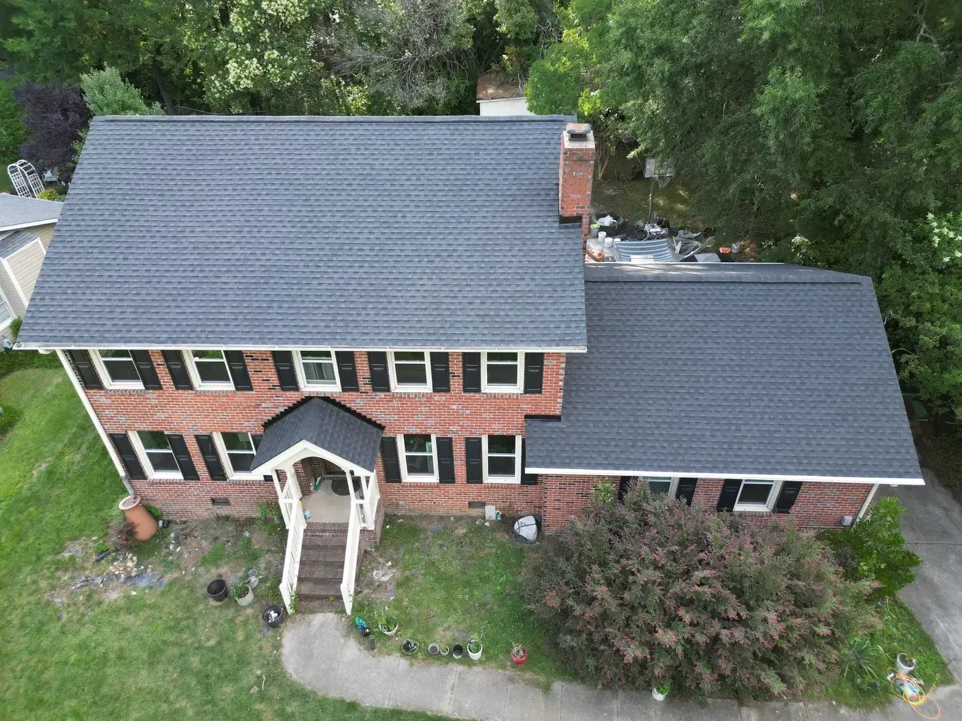 Close-up of a finished roof repair section on Buckingham Rd in Garner, NC with matching GAF Charcoal shingles