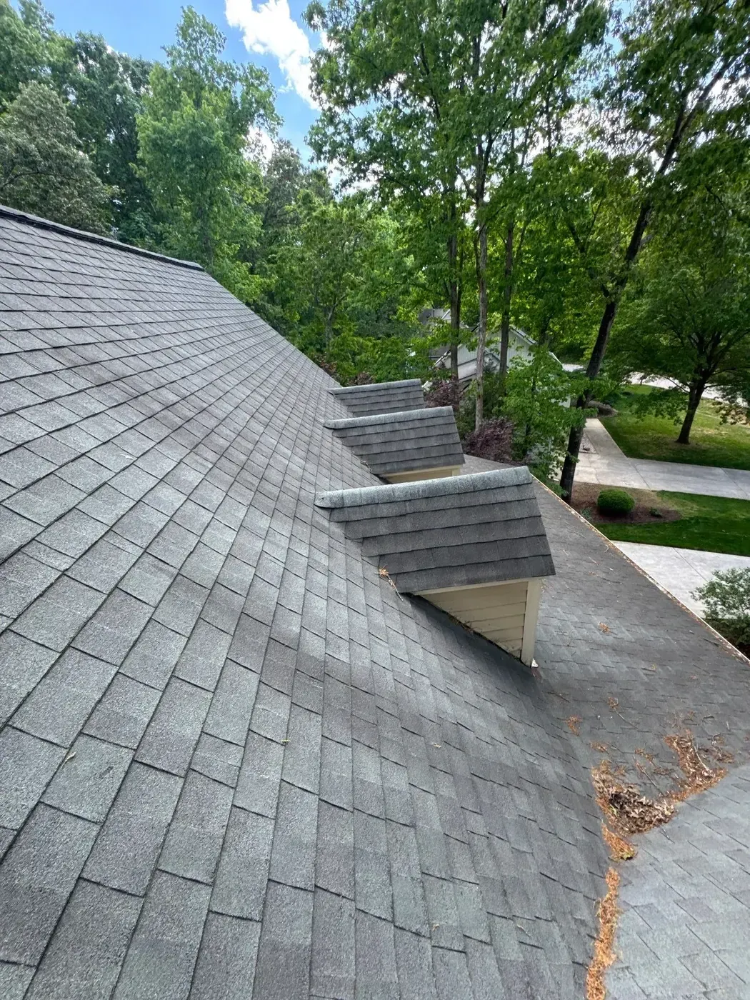 On Tops Roofing team member performing a roof inspection on a Cary, NC home