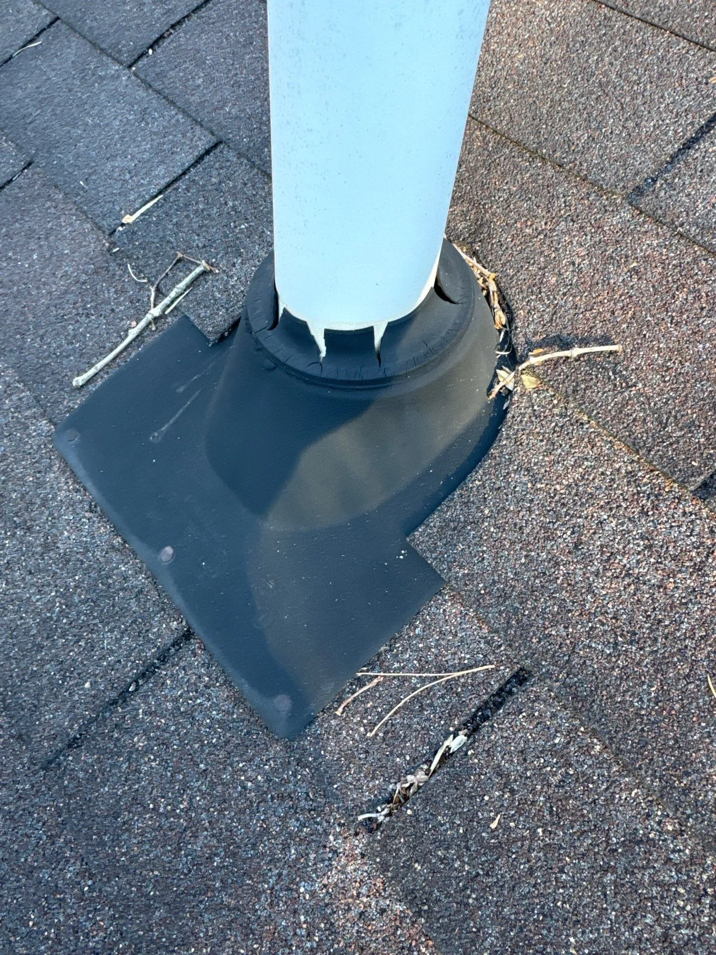 Cracked and broken neoprene pipe boot on a residential roof in North Carolina, showing deterioration after only 6-8 years
