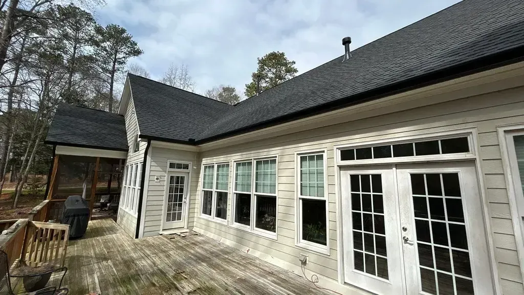Home in Apex with newly installed black 6-inch gutters along the roofline