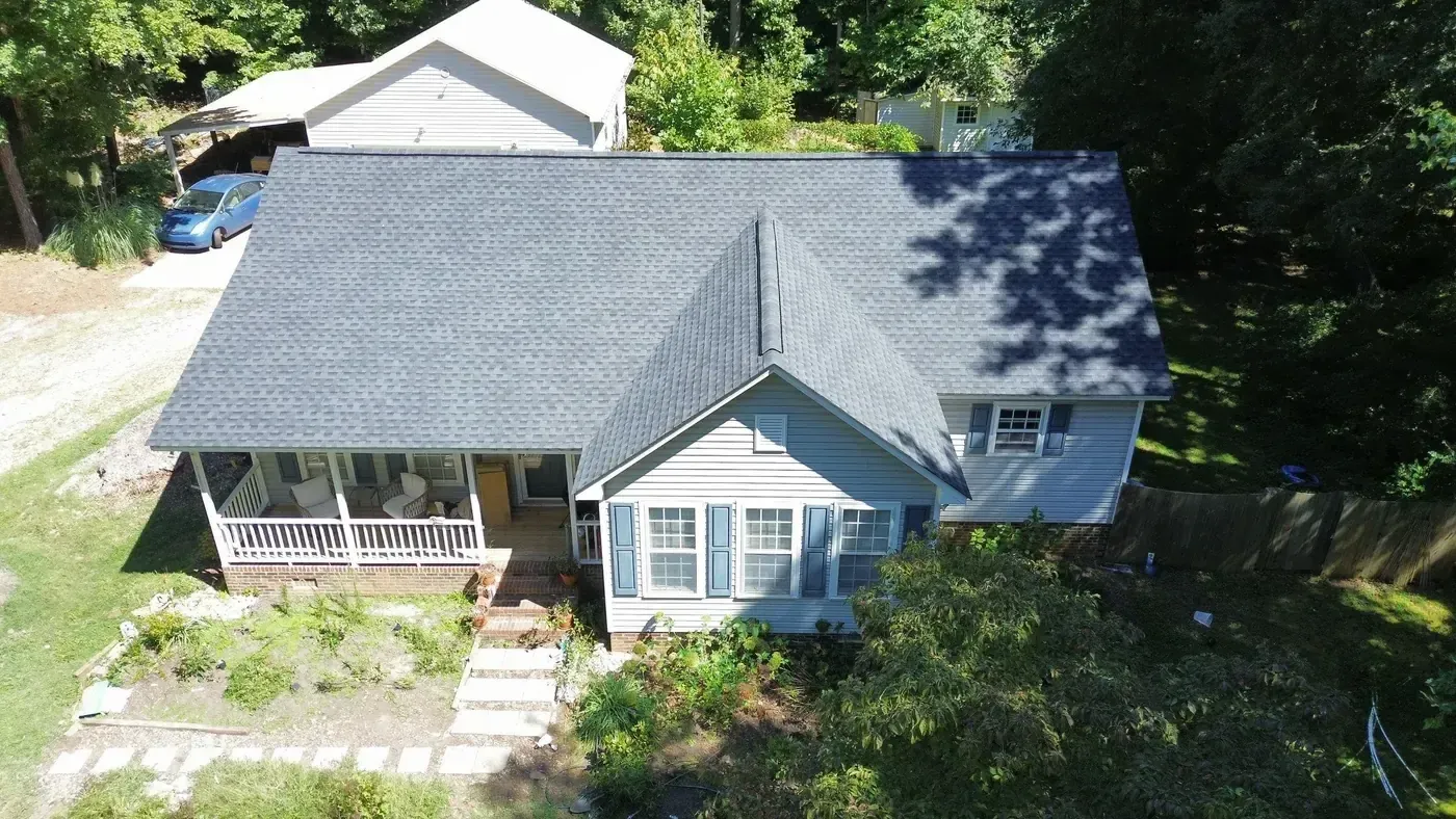 Close-up of a finished roof repair section on Piney Grove Church Rd in Hillsborough, NC with matching GAF Charcoal shingles