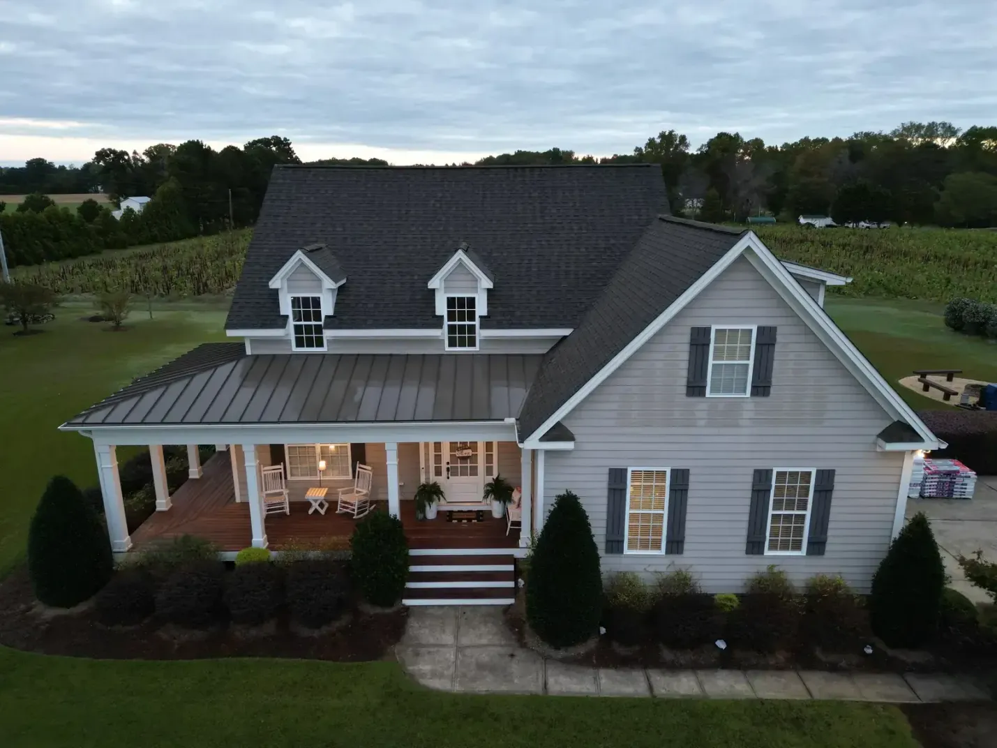 Farmhouse in Holly Springs, NC with metal porch roofs and a newly completed main roof