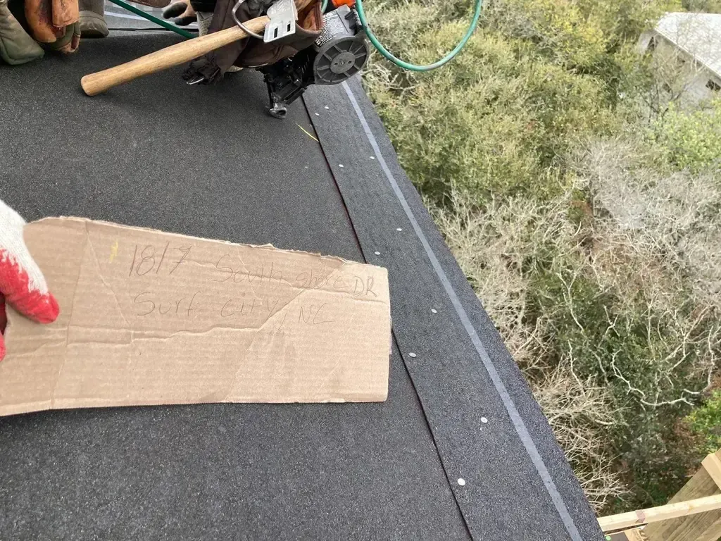 Self-adhered peel-and-stick starter strip being installed along the roof edge on a FORTIFIED roof in North Carolina